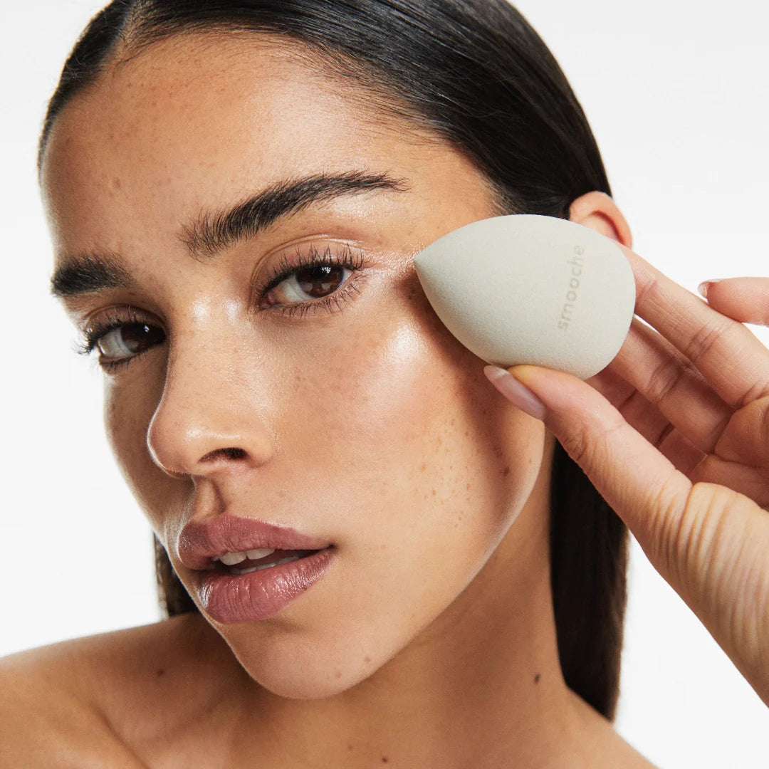 Using a pink Smooche Blender sponge to blend foundation for a streak-free, airbrushed complexion finish.