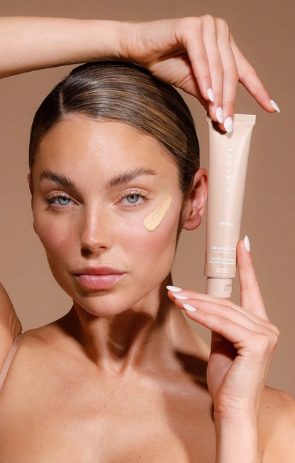 Golden Glow SPF50+ Dreamscreen 75ml woman with product